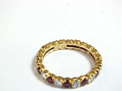 Lot 37 - An 18ct gold ruby and diamond full eternity ring by Boucheron