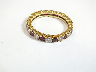 Lot 37 - An 18ct gold ruby and diamond full eternity ring by Boucheron