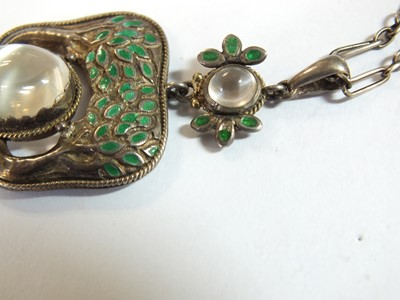 Lot 133 - An Arts and Crafts moonstone and enamel pendant in the style of Jessie M King