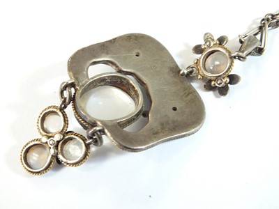 Lot 133 - An Arts and Crafts moonstone and enamel pendant in the style of Jessie M King