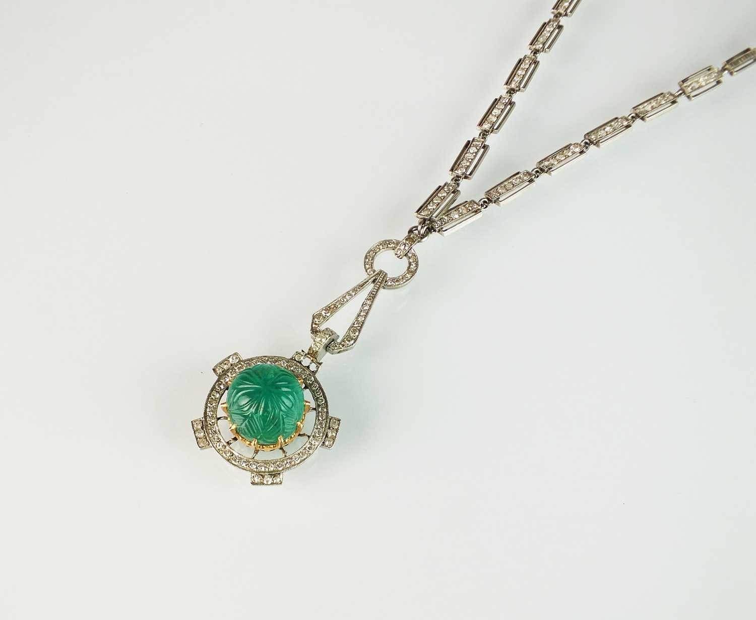 108 - An Art Deco emerald and diamond pendant on chain