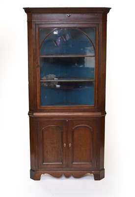 Lot 629 - A George III oak glazed standing corner cabinet