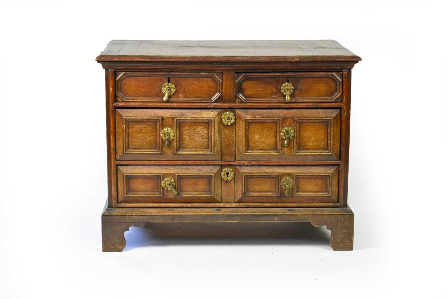 Lot 48 - A 17th century style oak geometric chest of two short over two long drawers