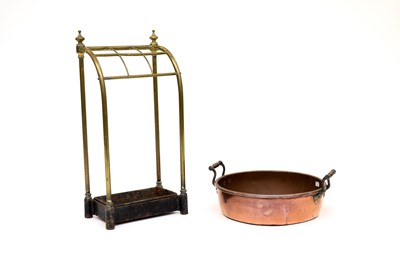 Lot 250 - A brass umbrella/stick stand and a copper jam pan