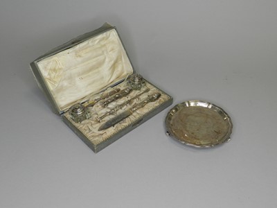 Lot 134 - A silver waiter and a silver mounted writing set