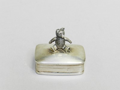 Lot 7 - A sterling silver pill box with teddy bear finial