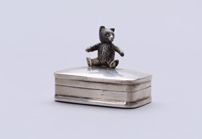 Lot 7 - A sterling silver pill box with teddy bear finial