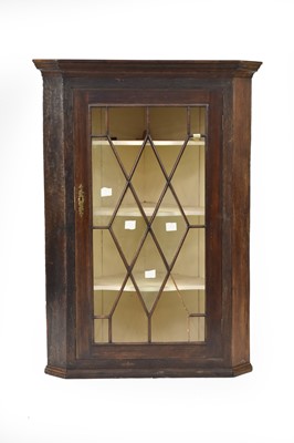 Lot 49 - A 19th century glazed hanging corner cupboard