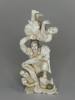 Lot 239 - A Japanese ivory okimono of street performers