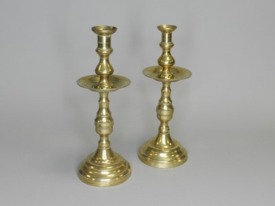 Lot 330 - A near pair of 19th/20th century brass candlesticks