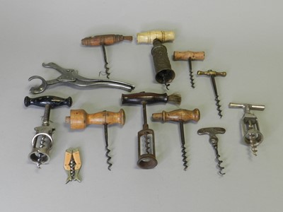 Lot 292 - A collection of early 19th century and later cork screws, including a turned bone handled example with an embossed base