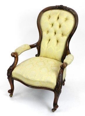 Lot 387 - A Victorian carved walnut spoon-back armchair