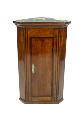 Lot 373 - A 19th century oak and mahogany crossbanded hanging corner cupboard