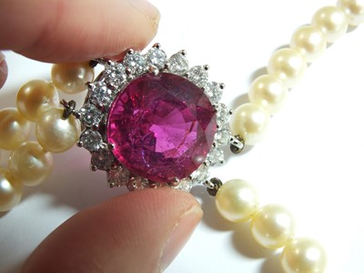 Lot 49 - A pink tourmaline and diamond cluster on two strand cultured pearl necklace