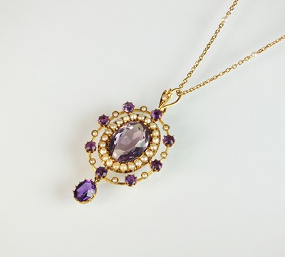 Lot 135 - An early 20th century amethyst and seed pearl pendant on chain