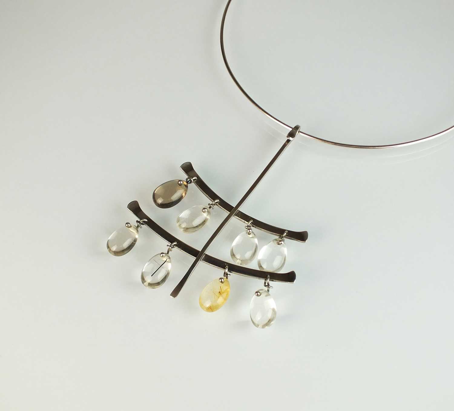 Lot 43 - A Georg Jensen silver neck ring and rutilated quartz pendant