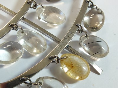 Lot 43 - A Georg Jensen silver neck ring and rutilated quartz pendant