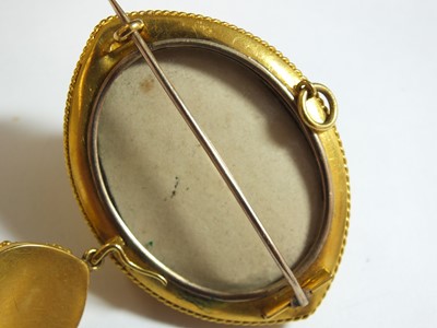 Lot 125 - A Victorian garnet, pearl and enamel locket brooch