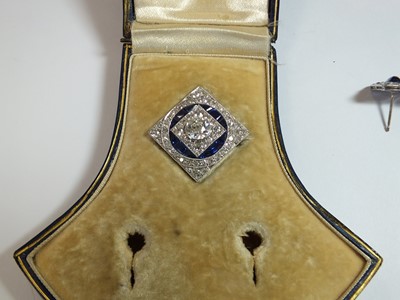 Lot 58 - An Art Deco diamond and sapphire brooch with associated earrings