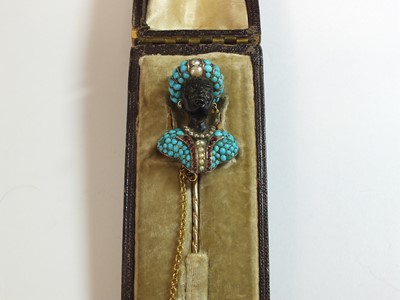 Lot 102 - An early Victorian turquoise, pearl, diamond and garnet Blackamoor pin