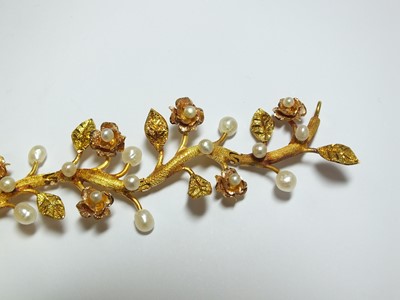 Lot 111 - A pearl set stylised flower bracelet