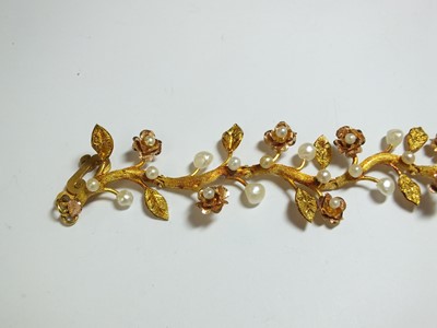 Lot 111 - A pearl set stylised flower bracelet