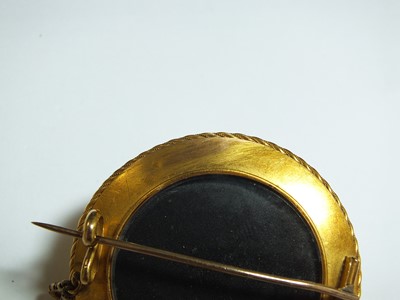 Lot 129 - A Victorian garnet set locket brooch, designed...