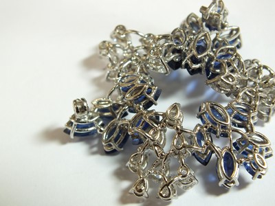 Lot 105 - A diamond and sapphire stylised leaf cluster brooch