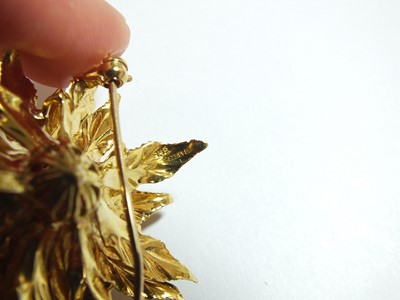 Lot 64 - An 18ct gold ruby set flower brooch
