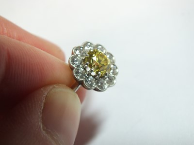 Lot 57 - A yellow and white diamond floral cluster ring