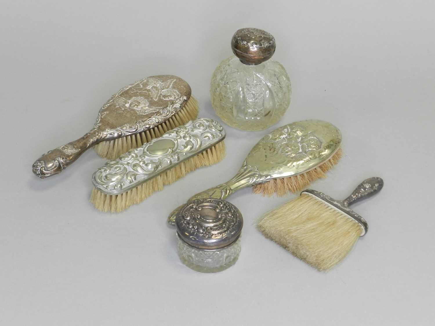 Lot 154 - A silver topped glass perfume bottle