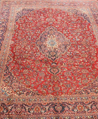Lot 656 - A large red-ground Persian Kashan carpet