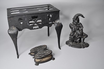 Lot 171 - A 19th century wrought iron footman, a Punch doorstop and a foot pump (3)