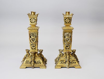 Lot 517 - A pair of late 19th century, Louis XIV style, brass candlesticks