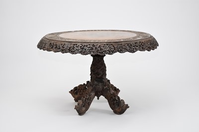 Lot 412 - A large Burmese carved hardwood tilt-top table