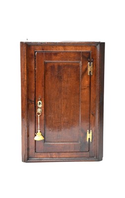 Lot 562 - An 18th century, vernacular oak hanging corner cupboard