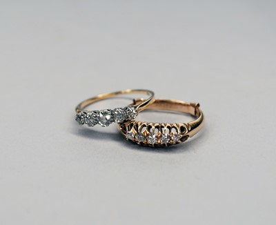 Lot 124 - Two five stone graduated diamond rings