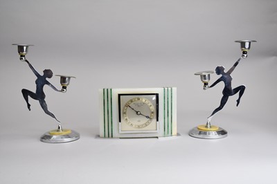 Lot 576 - An onyx and malachite inlaid Art Deco style mantel timepiece, with a pair of candlesticks (3)