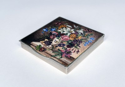 Lot 315 - An enamelled silver compact decorated with a vase full of flowers