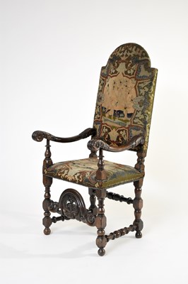 Lot 461 - A 17th century carved oak upholstered open armchair, probably Flemish