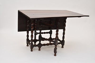 Lot 639 - An 18th century oak gateleg table
