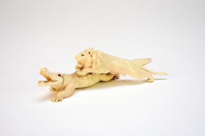 Lot 393 - A Japanese ivory okimono of a crocodile attacked by a lion