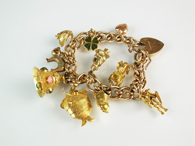 Lot 154 - A 9ct gold bracelet with attached charms