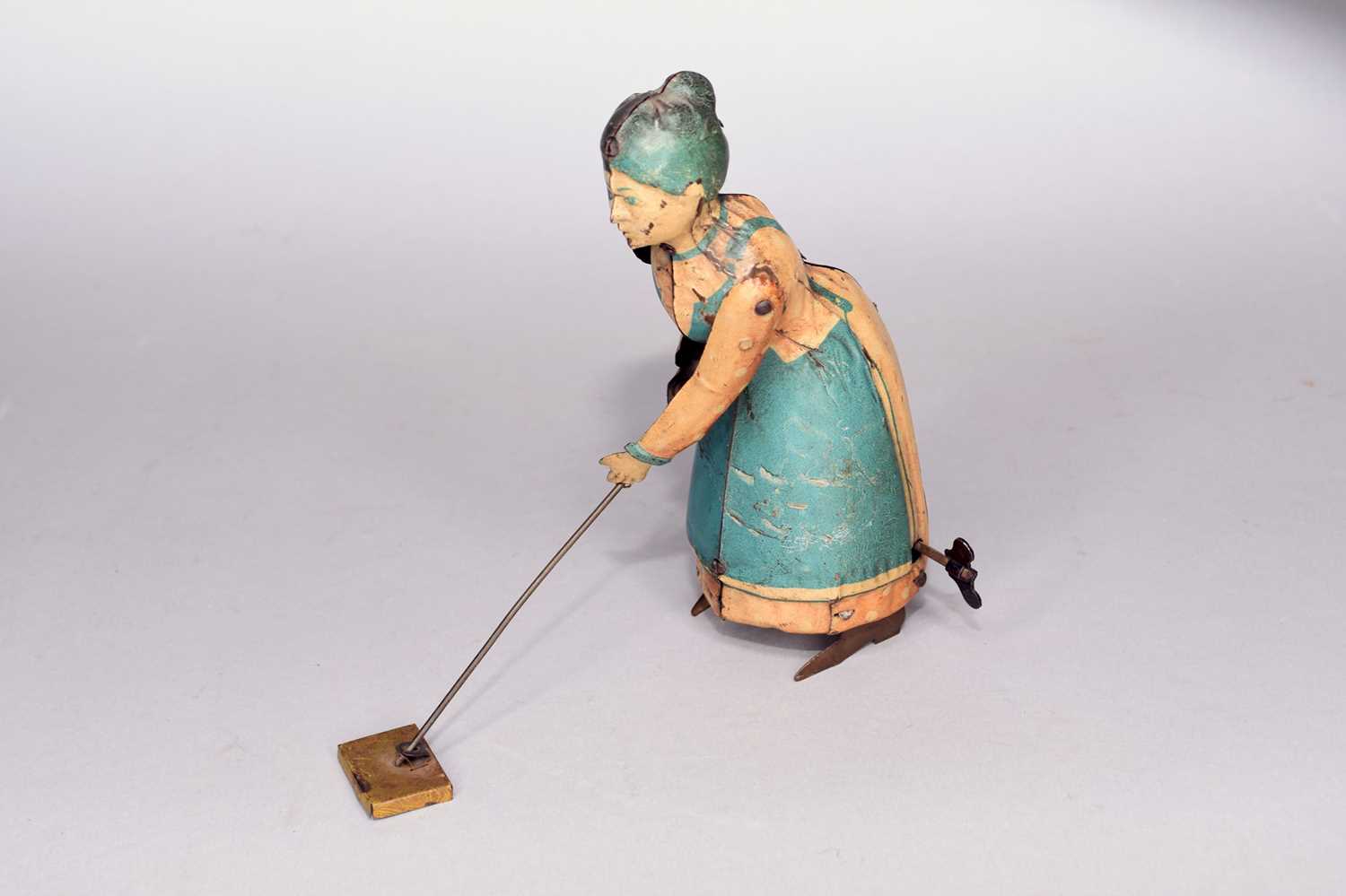 Lot 496 - A German made tin plate clockwork toy 'Bizzie Lizzie'