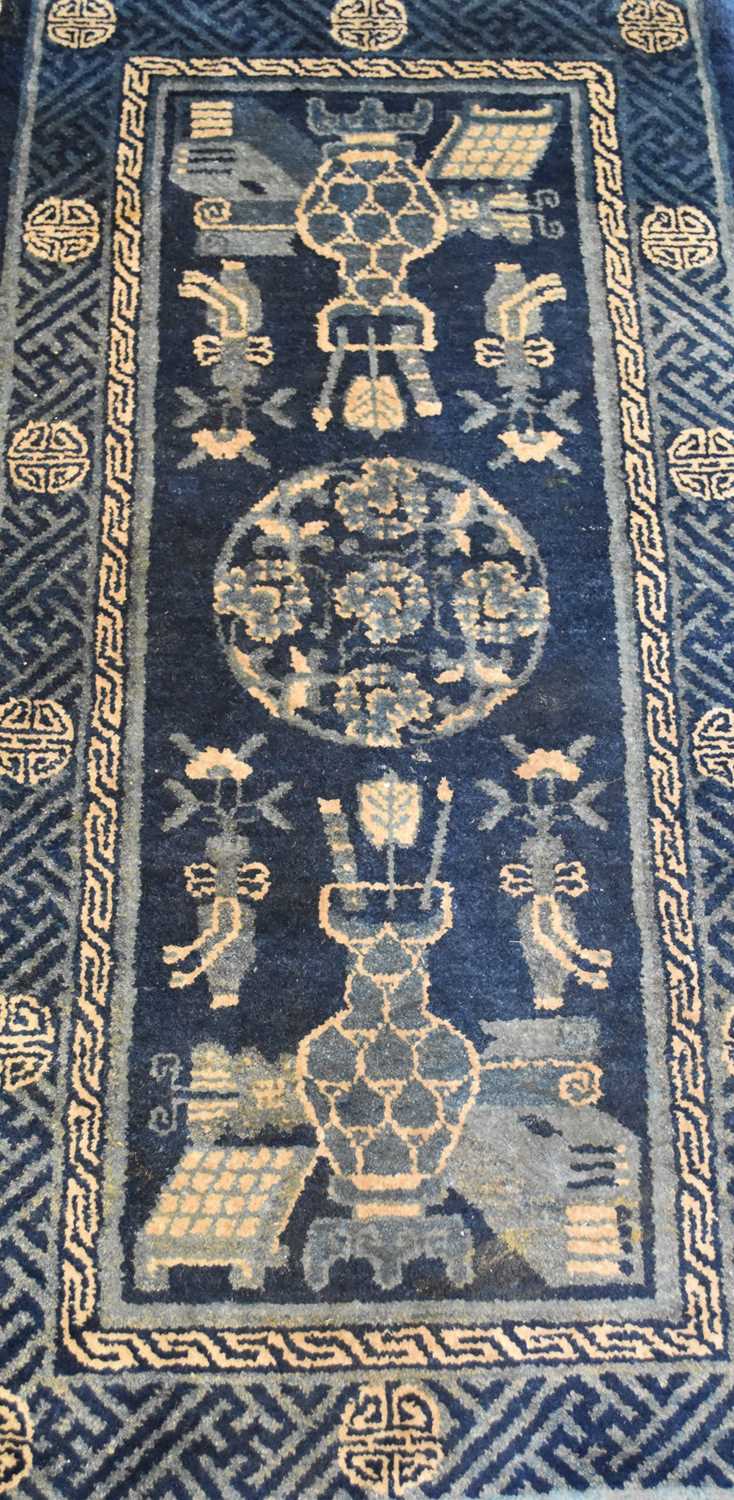 Lot 657 - A small Chinese rug