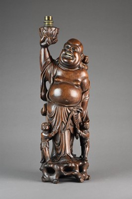 Lot 614 - A Chinese carved hardwood laughing Buddha table lamp