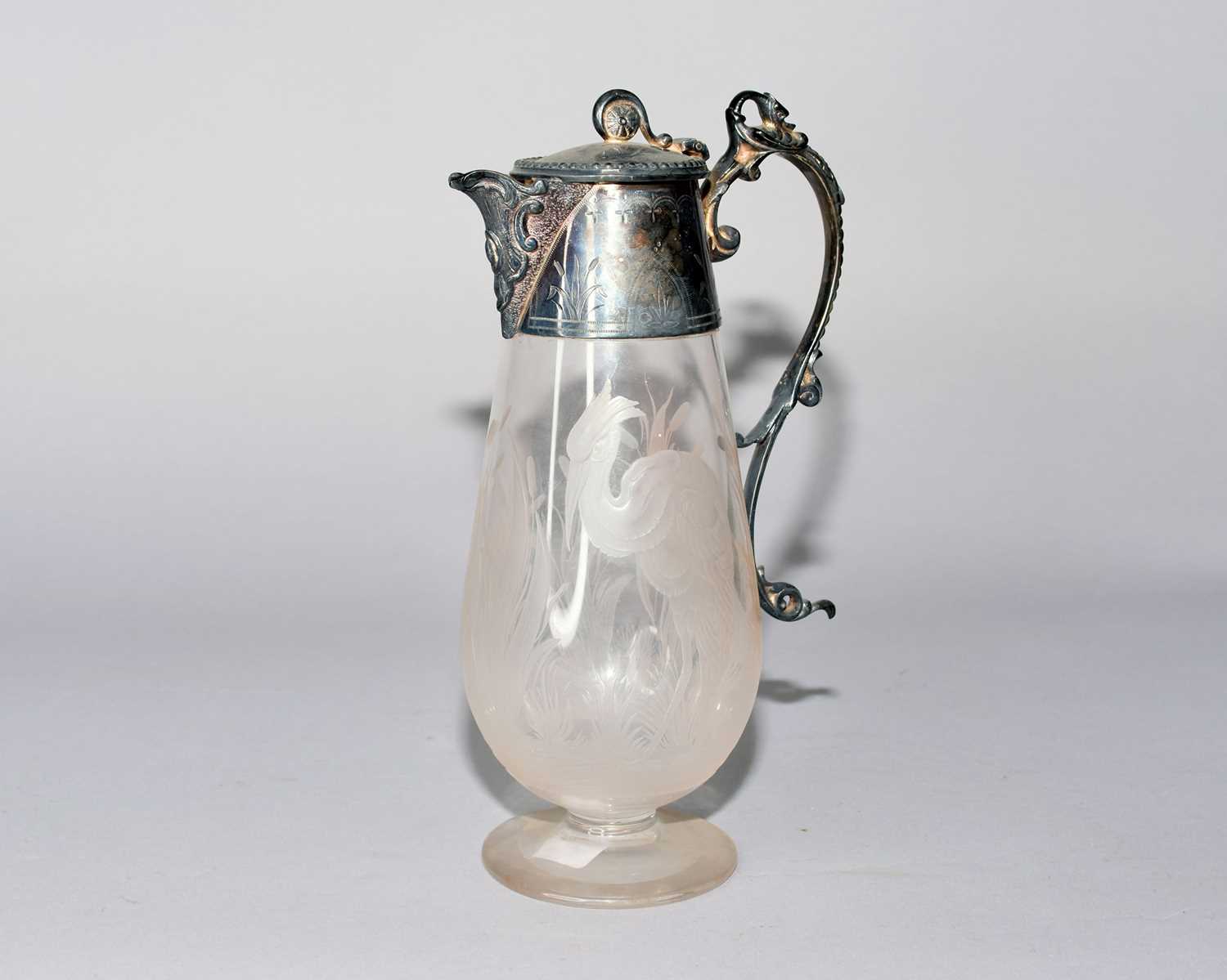 Lot 26 - An electroplated mounted glass jug