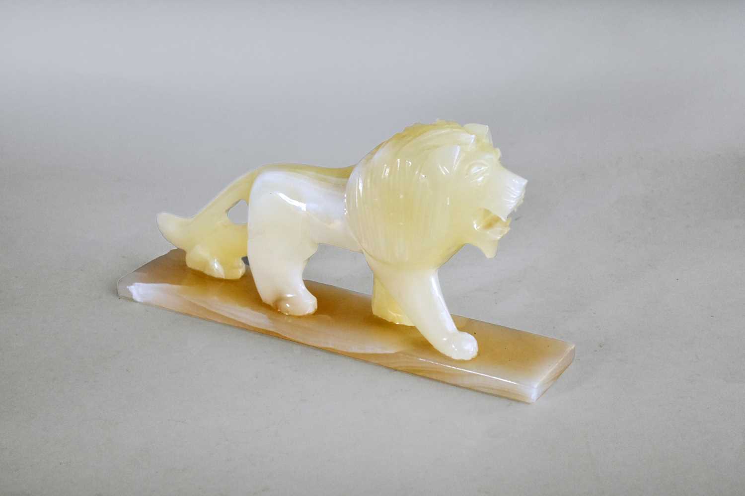 Lot 405 - An art deco style onyx figure of a lion