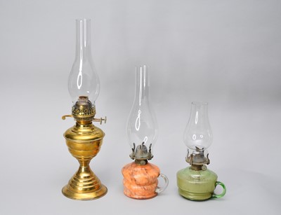 Lot 593 - A brass oil lamp and two glass oil lamps