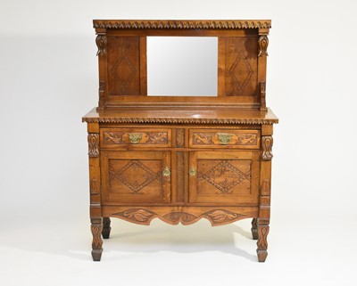 Lot 541 - An oak aesthetic movement influence carved mirror-back sideboard, dated 1933